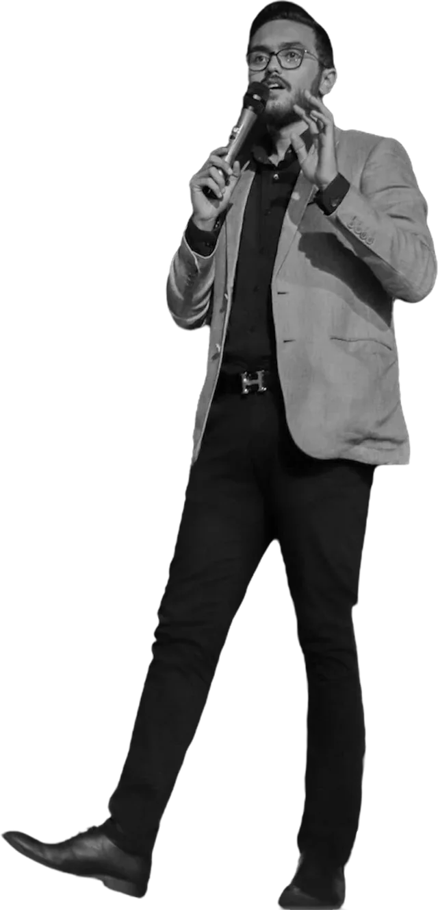 Abdelrahman speaking on stage with a microphone